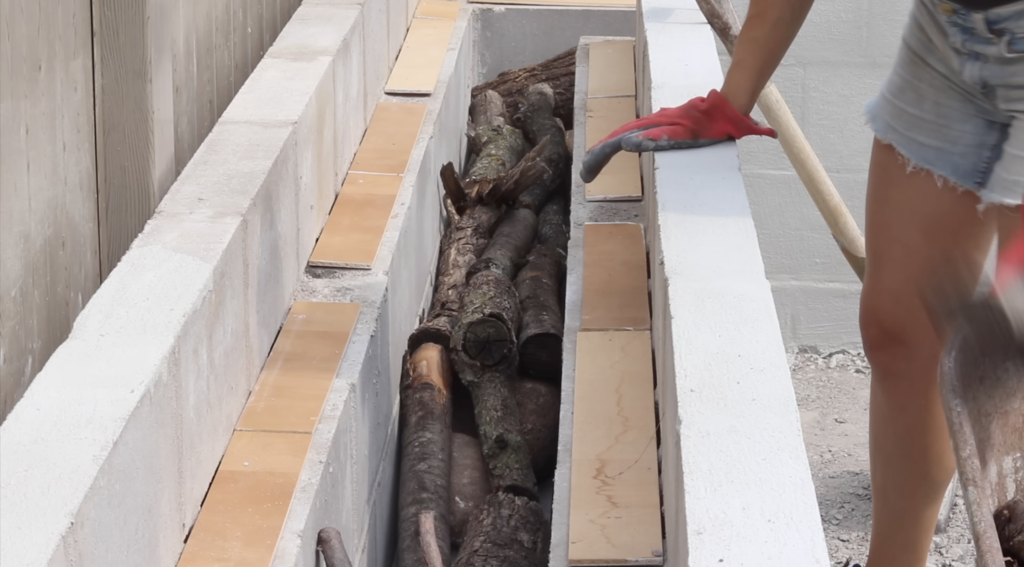 wood in the planter of the DIY Raised Concrete Garden Bed